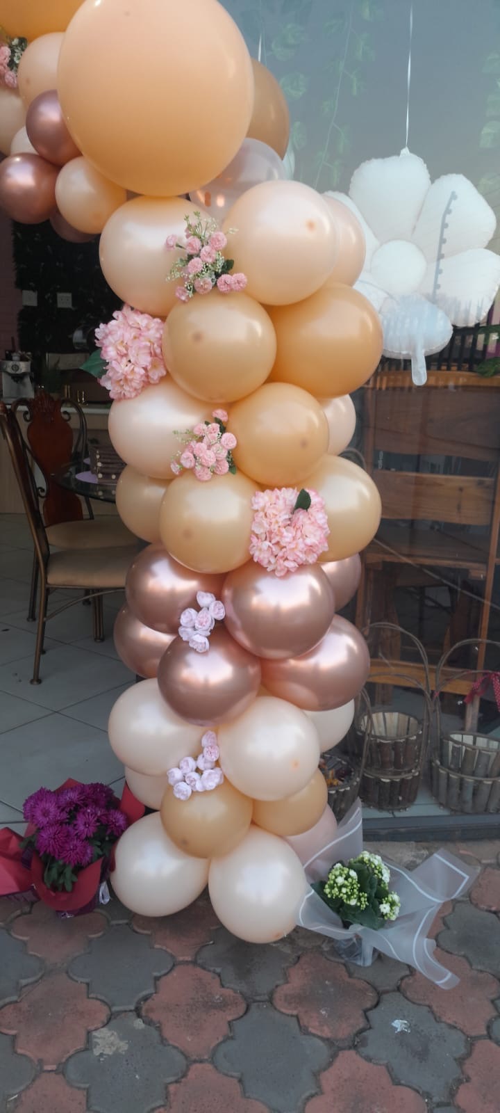 Blush, peach and rose gold balloon column with flowers
