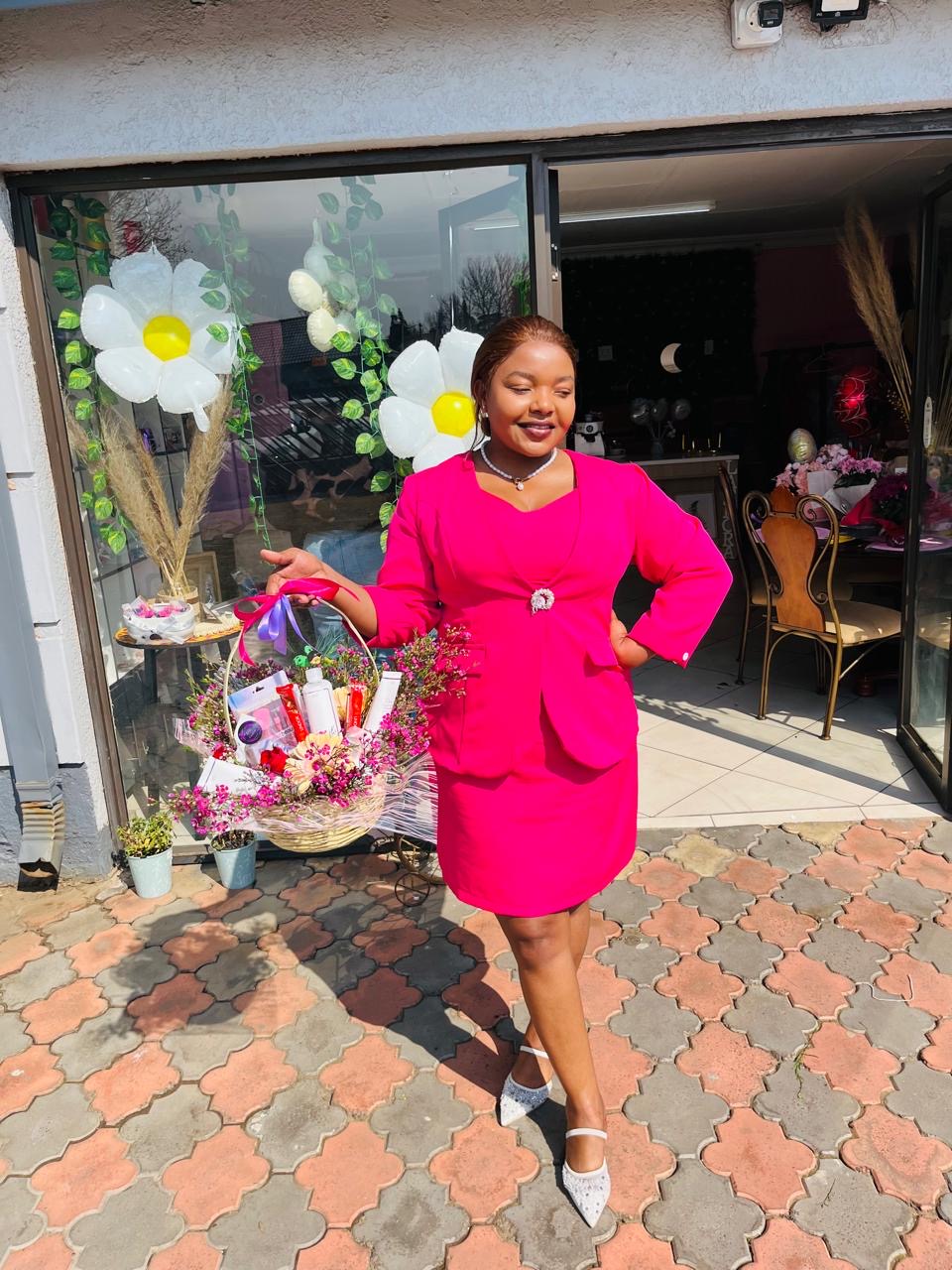 LaFlora Blooms florist holding a pamper flower basket outside the Kriel shop